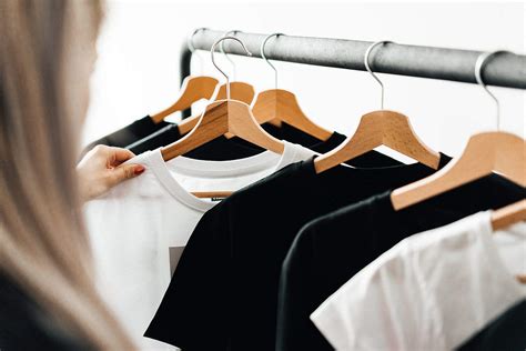 Woman Choosing T Shirts During Clothing Shopping At Apparel Store Free