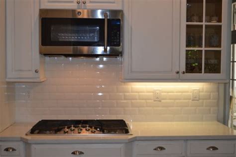 Beveled White Subway Tile In White Kitchen Quartz Marble Counters