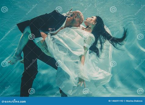 Beautiful Romantic Couple Of Bride And Groom After Wedding Swimming