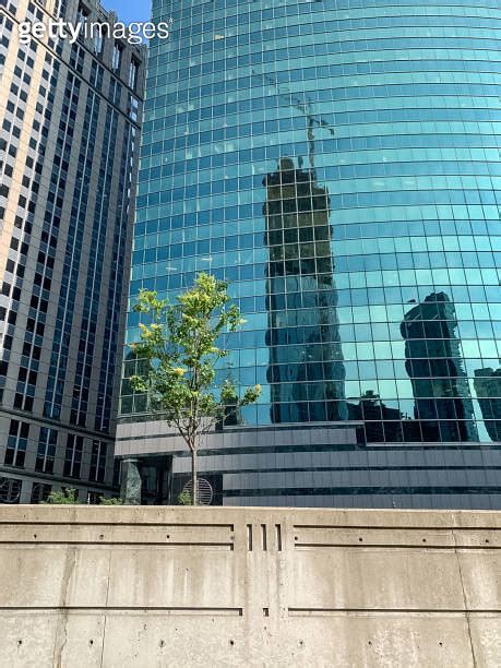 View Of Colorful Skyscraper And Concrete Wall Barrier Separating Upper