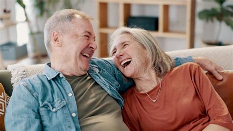 Laughing Love And Senior Couple Hug On A Sofa With Funny Conversation