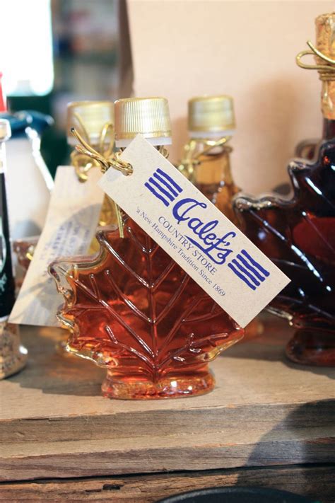 A Maple Leaf Shaped Glass Bottle With A Label On It