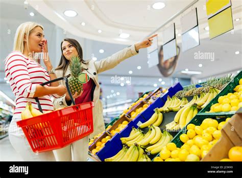 Beautiful Women Shopping Vegetables And Fruits In Supermarket Stock