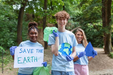 Diverse Group Of People Picking Up Trash In The Park Volunteer