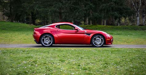 Download Striking Red Alfa Romeo 8c Competizione In Motion Wallpaper