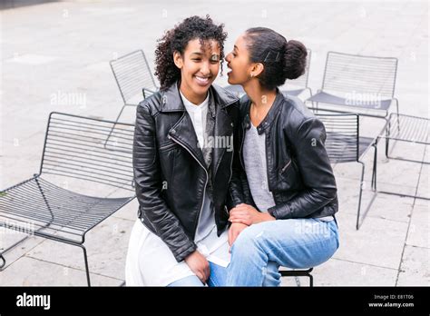 Two North African Teen Friends Sitting Together Whispering Stock Photo