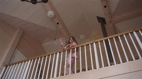 A Woman On A Balcony Taking A Selfie With A Hardwood Floor Beneath Her Feet Stock Video Video