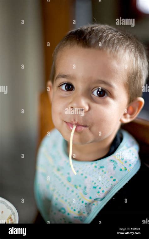 Boy eating spaghetti Stock Photo - Alamy