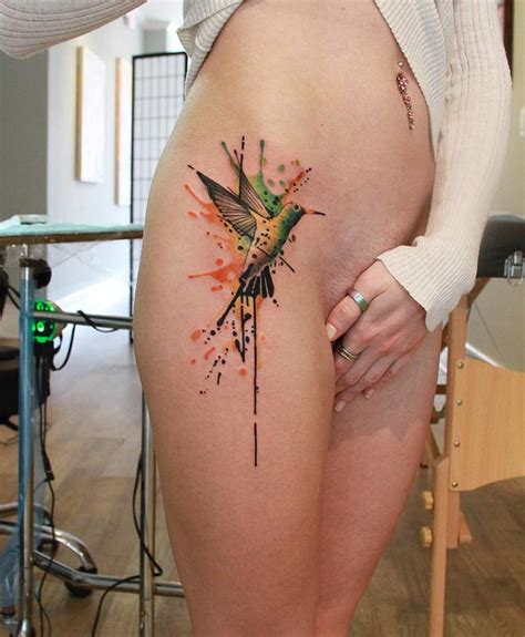 A Woman With A Hummingbird Tattoo On Her Thigh