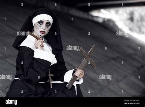 Portrait of woman dressed for Halloween as nun with cigar Stock Photo ...