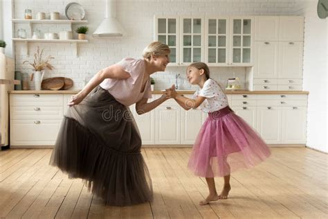 Mature Grandma Small Granddaughter Dance at Kitchen in Puffy Skirts ...