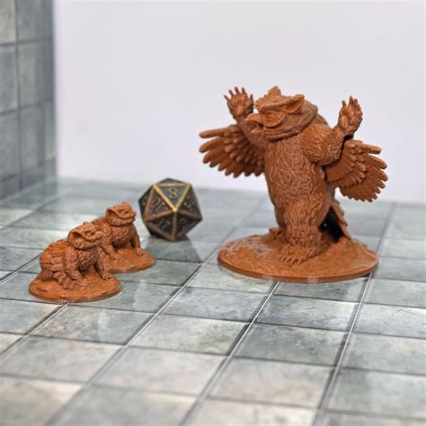 two small figurines on a tile floor next to a dice and an owl