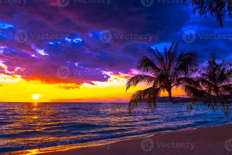 Beautiful Sunset Over The Sea On Tropical Beach With Palm Tree And Colorful Sky For Travel And