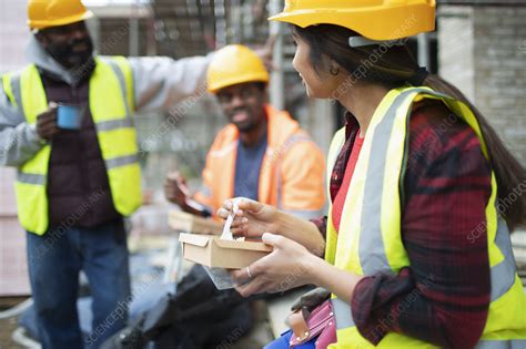 Construction Workers Eating Lunch At Construction Site Stock Image