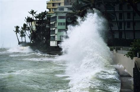 Hurricane Iniki storm waves crash over bank near hotels, 1992 | Natural ...