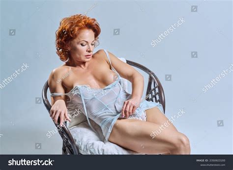 3 Middle Aged Sexy Woman Lingerie Sitting On Armchair White Studio