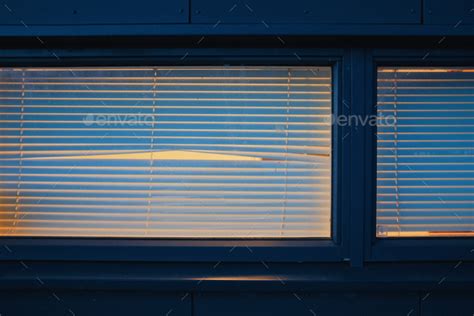 empty window with blinds and peephole at night Stock Photo by PaulSchlemmer