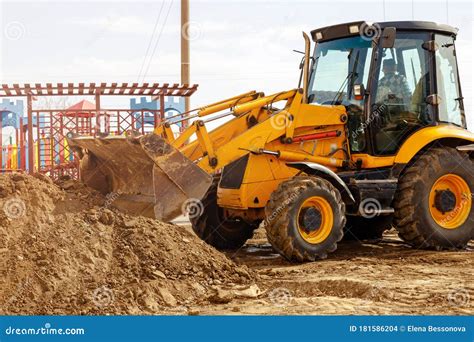 Excavator Tractor Digging A Trench For Pipenline At Construction Site