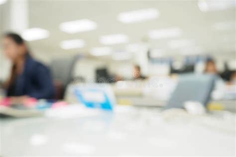 Office Blurred Background With People Working At Desk Stock Image