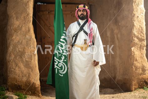 A Saudi Arabian Gulf man wearing the traditional Saudi folk costume, the traditional costume for ...