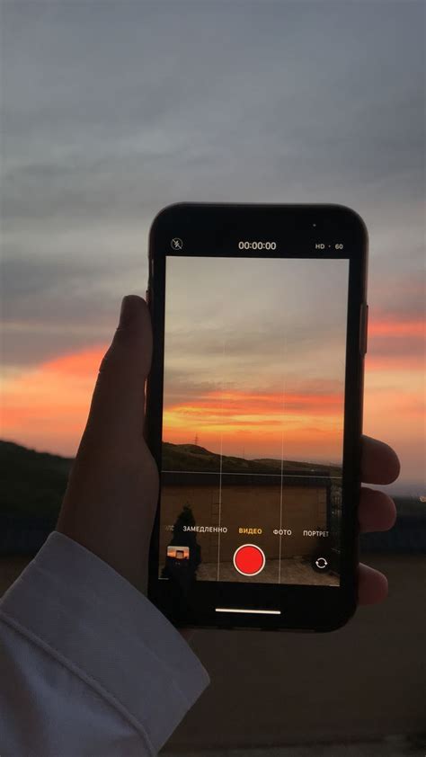 Someone Is Taking A Photo With Their Cell Phone At Sunset On The Beach