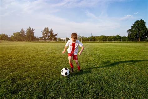 Boy Playing with Football Ball on Playing Field. Stock Photo - Image of ...