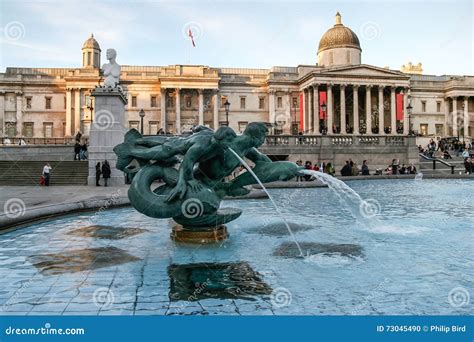 Fountain In Trafalgar Square With National Portrait Gallery In The