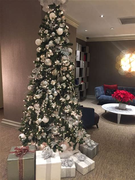 A Decorated Christmas Tree In The Middle Of A Living Room With Presents