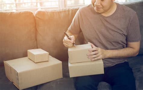 Premium Photo Midsection Of Man Holding Paper While Standing On Sofa At Home