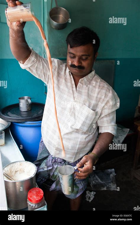 Chai Wallah Or Tea Maker Tea Man Pours His Chai Between Glasses Before Serving To Customers