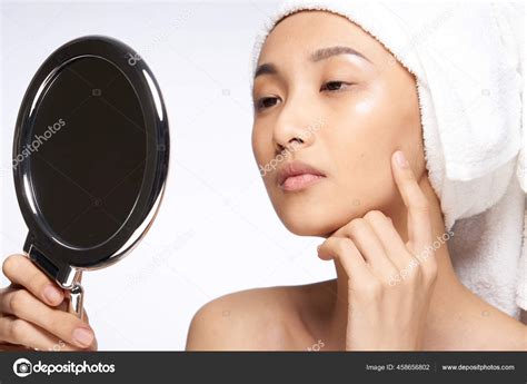 Asian Woman Naked Shoulders Touching Her Face With Her Hand And Looking