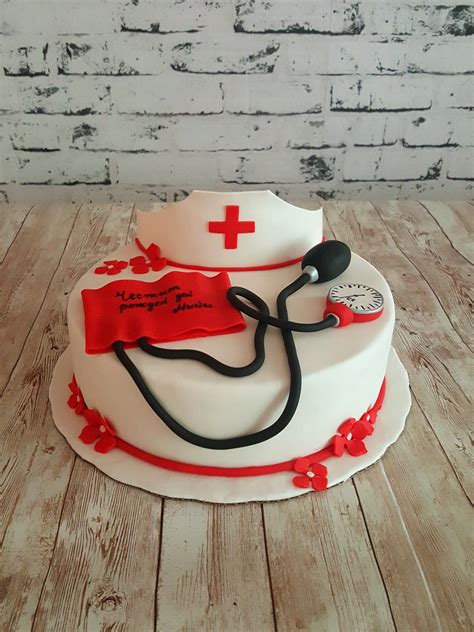 A Cake With A Stethoscope On It And Red Flowers Around The Edge