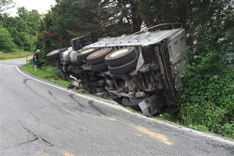 Dump truck flips over after being run off road