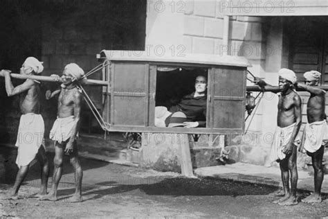 Four Indian Porters Carry A Westerner In A Palanquin Or Sedan Chair