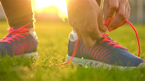 Running shoes - woman tying shoe laces. Slow motion 22917995 Stock ...