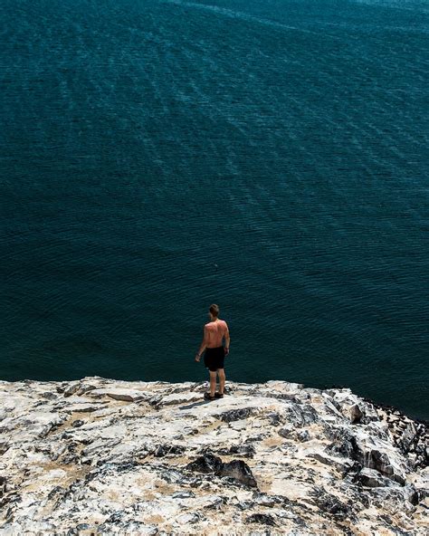 Hd Wallpaper Person Standing On Edge Of A Cliff Over Looking Body Of