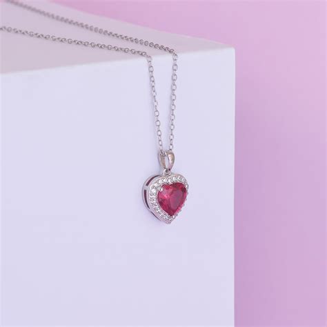 A Silver Necklace with a Heart Shaped Pendant · Free Stock Photo