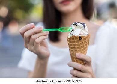 Hands Holding Melting Ice Cream Waffle Stock Photo