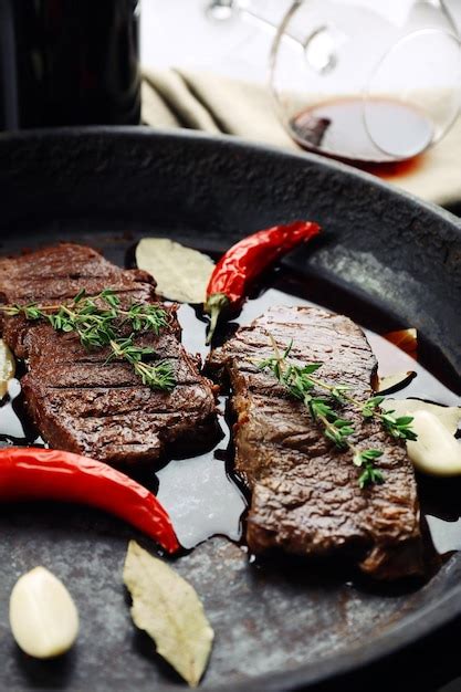 Premium Photo | Steak in frying pan on table close up