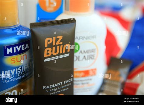 Suntan Lotions Beside A Red And White Stripped Bikini At The Beach Stock Photo Alamy