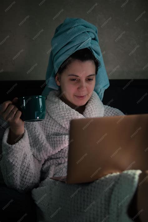 Premium Photo | Woman laying down in bed with wet head covered with