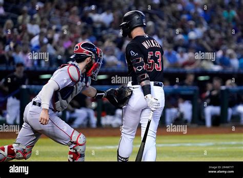 Boston Red Sox catcher Connor Wong, left, tags out Arizona Diamondbacks ...