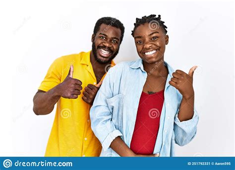 Young African American Couple Wearing Casual Clothes Success Sign Doing