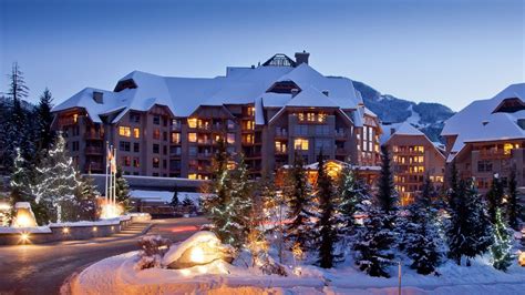 Snowy Four Seasons Hotel Whistler Ski Lodge At Dusk With Illuminated