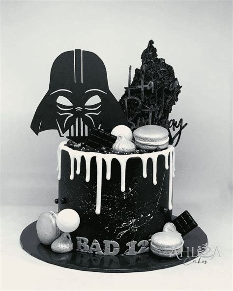 A Darth Vader Cake Is Decorated With Icing And Cookies On The Side