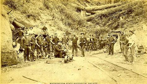 a group of men standing next to each other on a dirt road