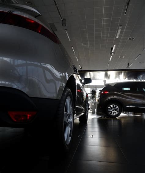 Premium Photo | New Cars In Showroom In A Dealership Center