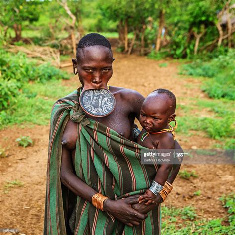 Woman From Mursi Tribe Breasfeeding Her Baby Mursi Tribe Are