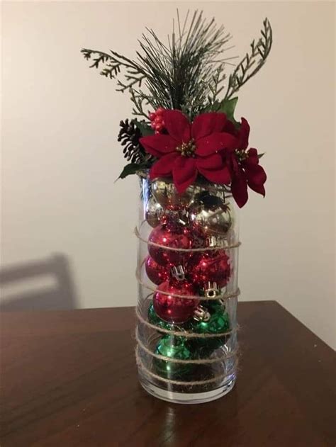 A Vase Filled With Ornaments On Top Of A Wooden Table