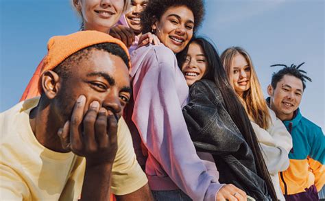 Multiracial Group Of Young Friends Bonding Outdoors Stock Photo